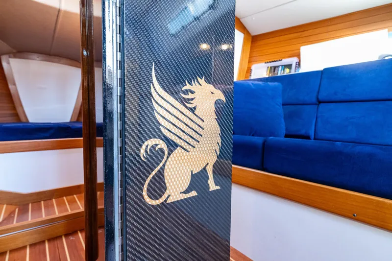 Slide: The Image of Interior of 2007 J Boats J/124 yacht with griffin emblem and blue seating. - 21