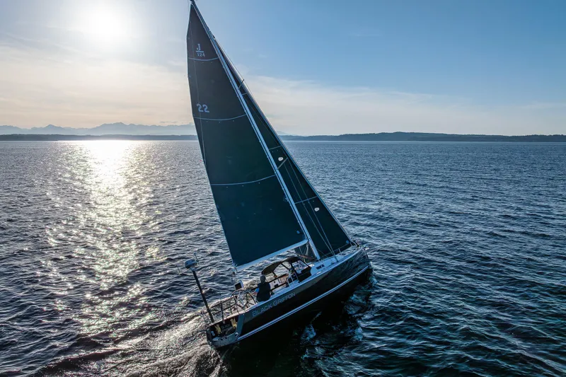 Slide: The Image of Sailing yacht J/124 from 2007 gliding on open water at sunset. - 4