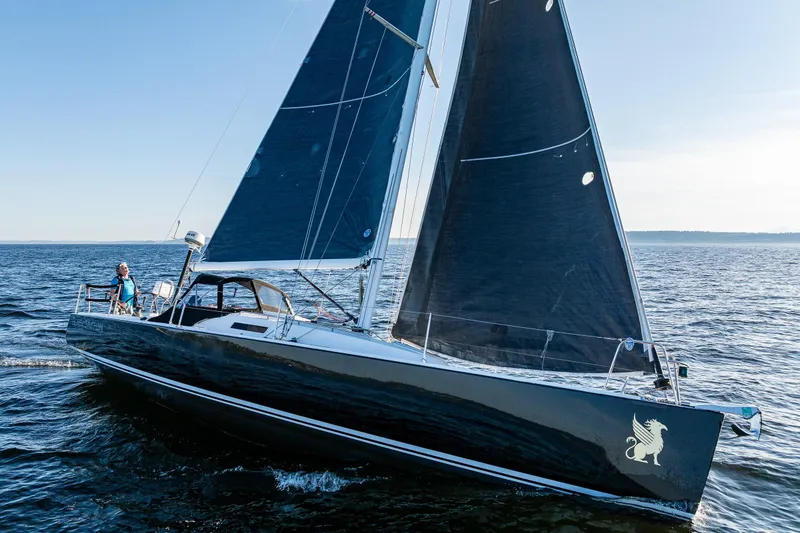 Slide: The Image of 2007 J Boats J/124 sailing on open water with sleek design and dark sails. - 7