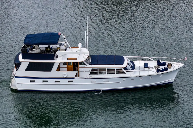 Slide: The Image of Aerial view of a 1969 Burger Flush Deck yacht cruising on the water. - 11