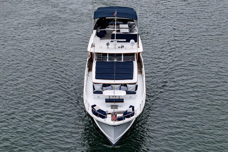 Slide: The Image of 1969 Burger Flush Deck yacht on water, aerial view, featuring sleek design and spacious deck. - 12