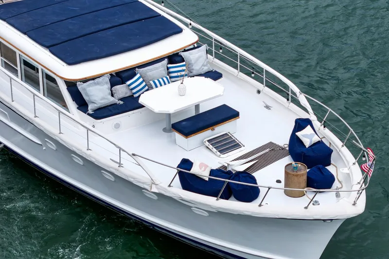 Slide: The Image of 1969 Burger Flush Deck yacht with elegant seating and nautical decor on calm waters. - 14