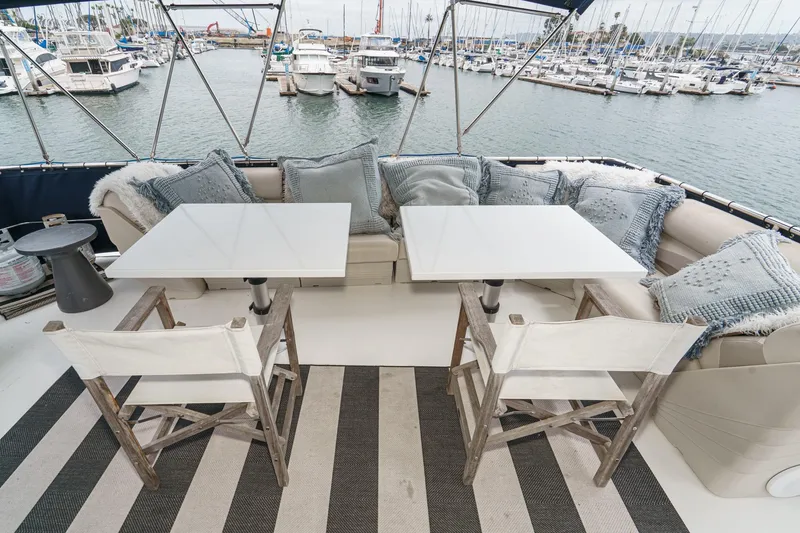 Slide: The Image of Cozy seating area on 1969 Burger Flush Deck yacht with marina view. - 21
