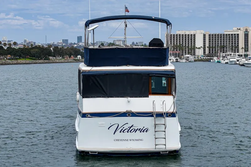 Slide: The Image of 1969 Burger Flush Deck yacht "Victoria" on water, cityscape in background. - 26