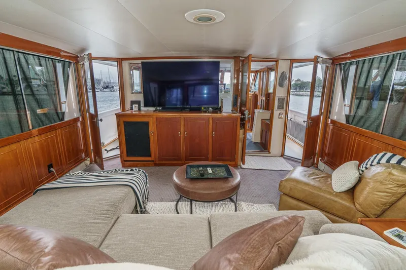 Slide: The Image of Luxurious 1969 Burger Flush Deck yacht interior with cozy seating and large TV. - 28