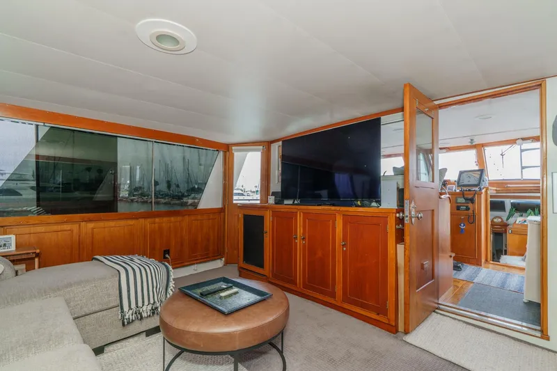 Slide: The Image of 1969 Burger Flush Deck yacht interior with wood paneling, cozy seating, and large windows. - 31