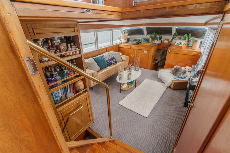 Slide: The Image of Interior of a 1969 Burger Flush Deck yacht with cozy seating and wooden accents. - 32