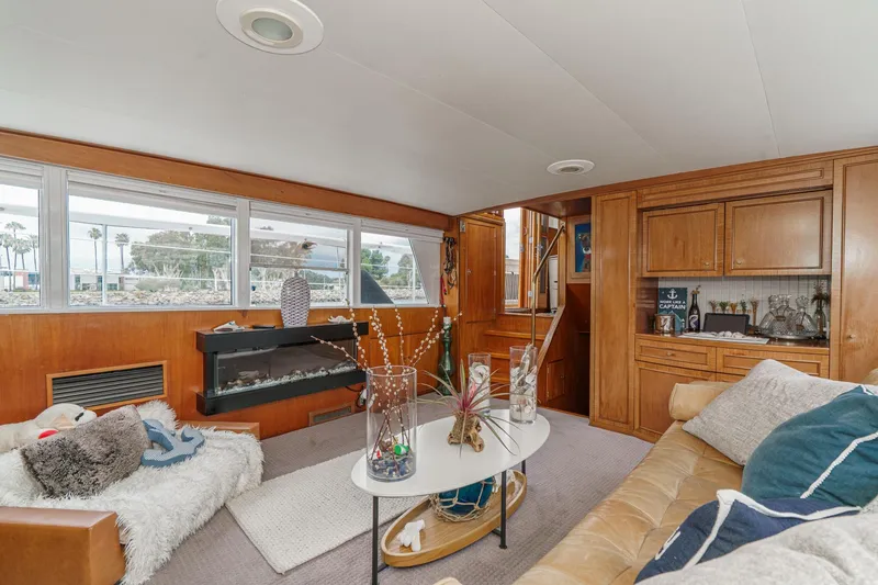 Slide: The Image of Interior of a 1969 Burger Flush Deck yacht with cozy seating and wooden cabinetry. - 35