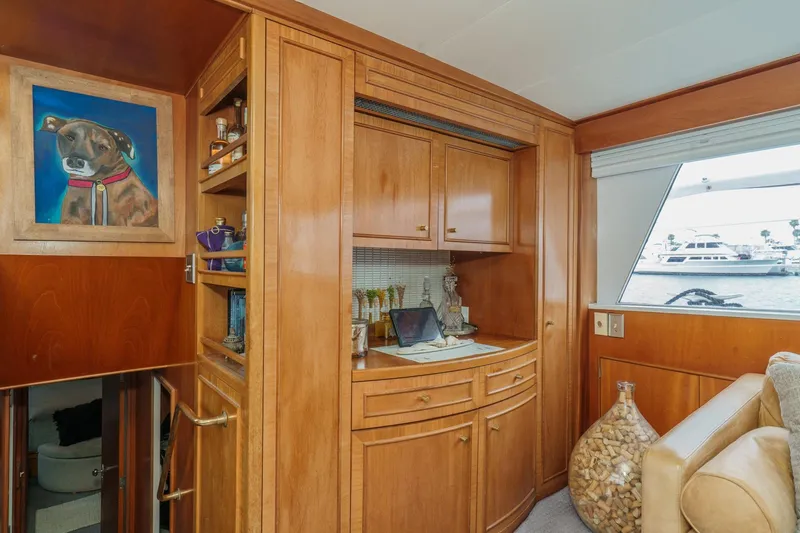 Slide: The Image of Interior of 1969 Burger Flush Deck yacht with wooden cabinetry and dog painting. - 38