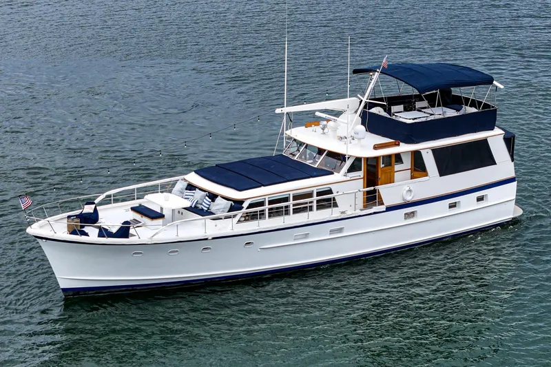 Slide: The Image of Classic 1969 Burger Flush Deck yacht with elegant design on calm waters. - 4