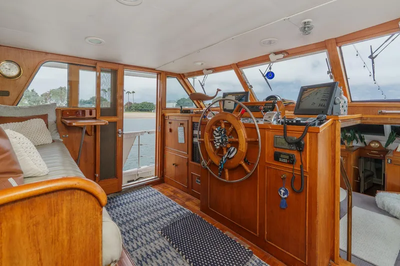 Slide: The Image of Interior of a 1969 Burger Flush Deck yacht with wooden helm and navigation equipment. - 40