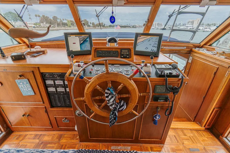 Slide: The Image of Vintage 1969 Burger Flush Deck yacht helm with wooden wheel and navigation equipment. - 43