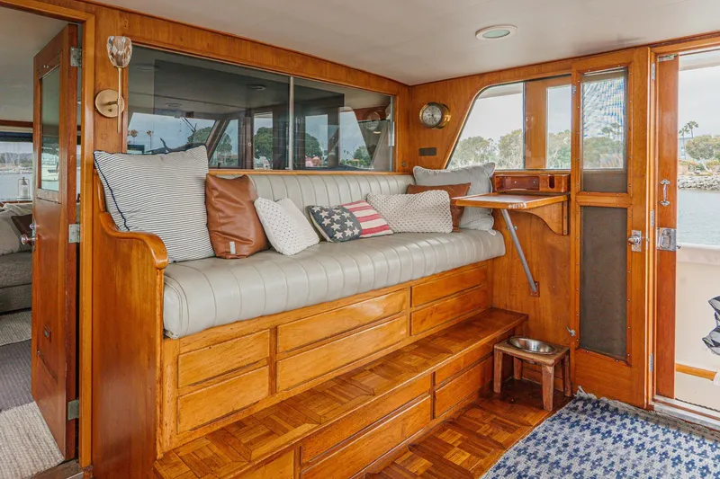 Slide: The Image of Vintage 1969 Burger Flush Deck yacht interior with wooden seating and nautical decor. - 47