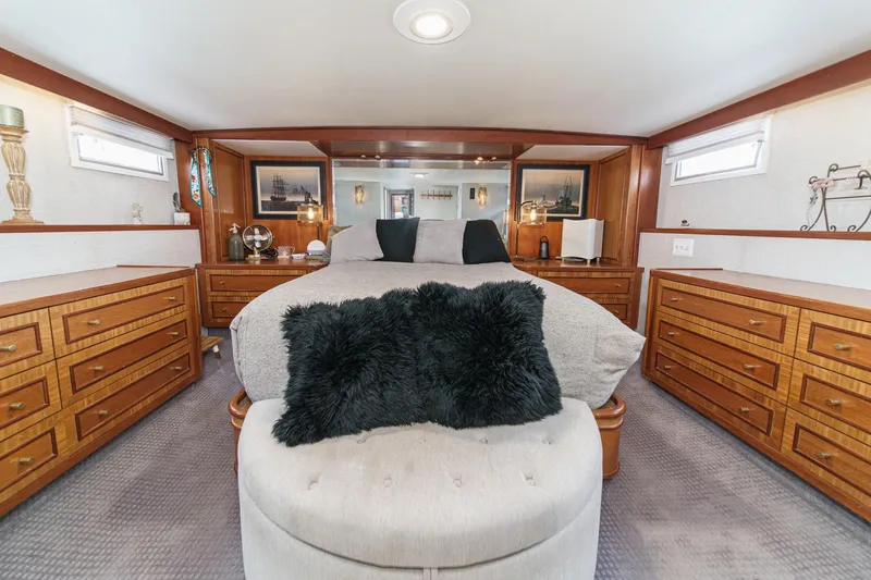 Slide: The Image of Luxurious 1969 Burger Flush Deck yacht bedroom with elegant wood furnishings and plush bedding. - 48