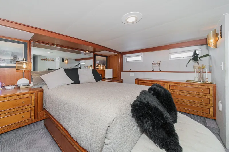 Slide: The Image of Luxurious bedroom interior on a 1969 Burger Flush Deck yacht, featuring elegant wood furnishings. - 49