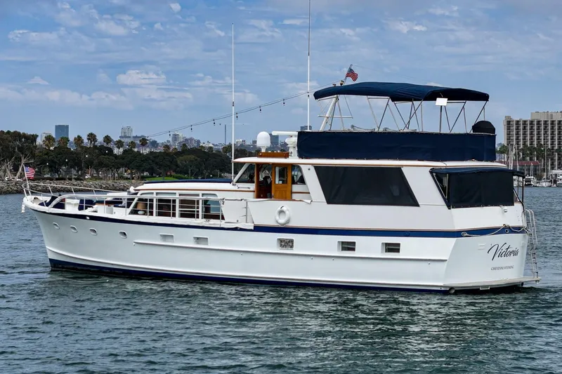 Slide: The Image of 1969 Burger Flush Deck yacht on water, featuring classic design and American flag. - 5