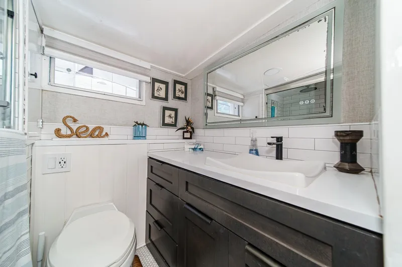 Slide: The Image of Modern bathroom on 1969 Burger Flush Deck yacht with sleek vanity and nautical decor. - 53