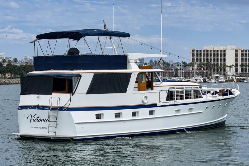 Slide: The Image of Classic 1969 Burger Flush Deck yacht on water, featuring elegant design and spacious deck. - 6