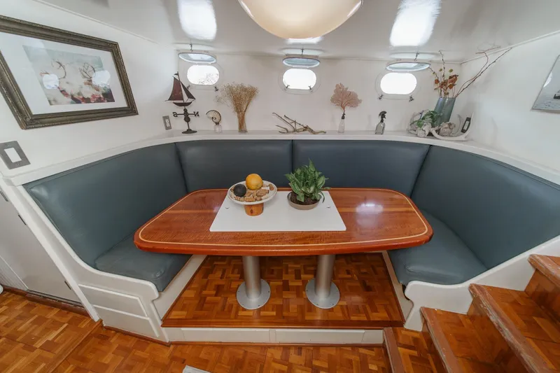Slide: The Image of Cozy dining nook on 1969 Burger Flush Deck yacht with wooden table and decor. - 60
