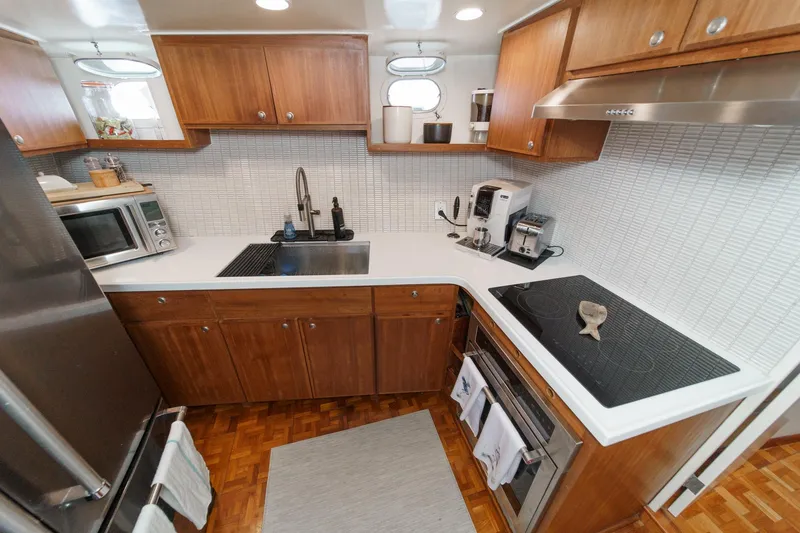 Slide: The Image of 1969 Burger Flush Deck yacht kitchen with modern appliances and wooden cabinetry. - 62