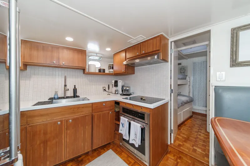 Slide: The Image of 1969 Burger Flush Deck yacht kitchen with wood cabinets and modern appliances. - 63