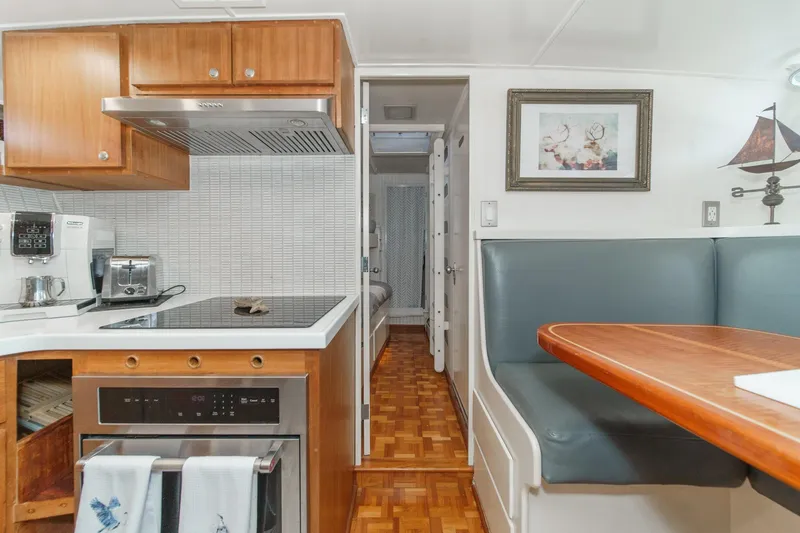 Slide: The Image of Interior of a 1969 Burger Flush Deck yacht with kitchen and dining area. - 64