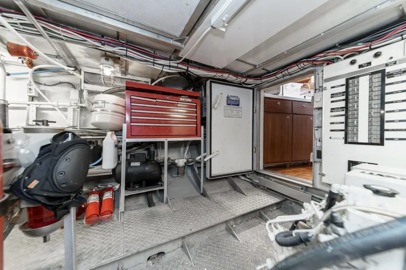 Slide: The Image of Engine room of a 1969 Burger Flush Deck yacht with tools and control panels. - 70