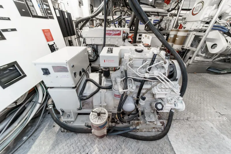 Slide: The Image of Engine room of a 1969 Burger Flush Deck yacht, featuring complex machinery and wiring. - 76