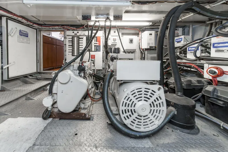 Slide: The Image of Engine room of a 1969 Burger Flush Deck yacht, showcasing machinery and wiring. - 78
