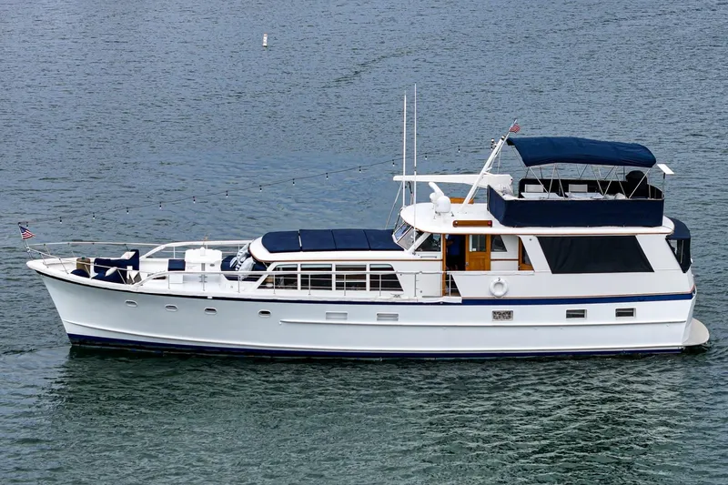 Slide: The Image of 1969 Burger Flush Deck yacht on calm water, featuring classic design and elegant structure. - 9