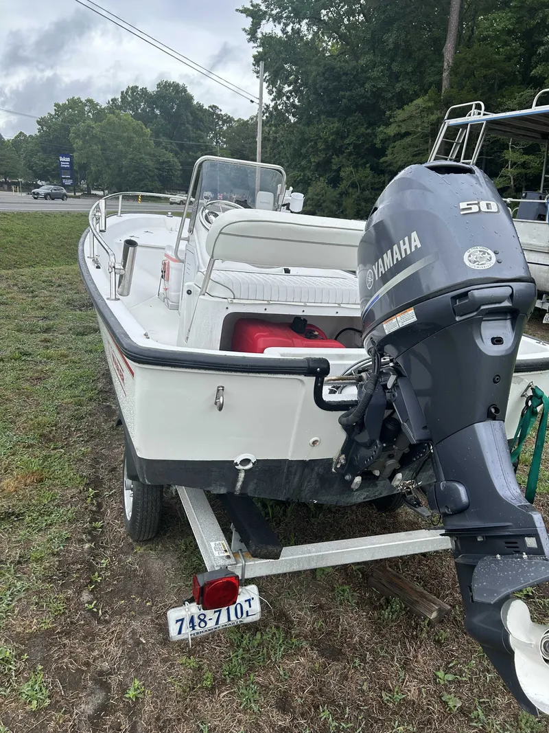 Slide: The Image of A 1997 Boston Whaler DAUNTLESS boat on a trailer with a Yamaha outboard motor. - 4