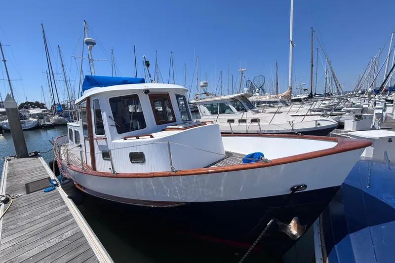 Slide: The Image of 1985 Transpacific Marine Pacific Eagle 32 docked at marina, surrounded by sailboats. - 1