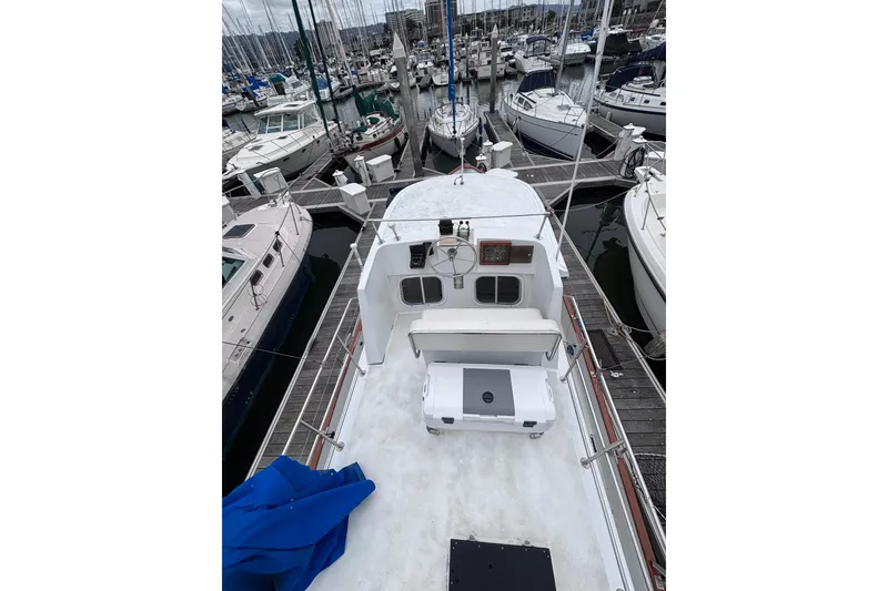 Slide: The Image of 1985 Transpacific Marine Pacific Eagle 32 yacht docked at marina, surrounded by other boats. - 11
