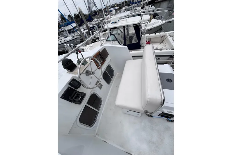 Slide: The Image of Cockpit of 1985 Transpacific Marine Pacific Eagle 32 yacht, featuring steering wheel and seating. - 12