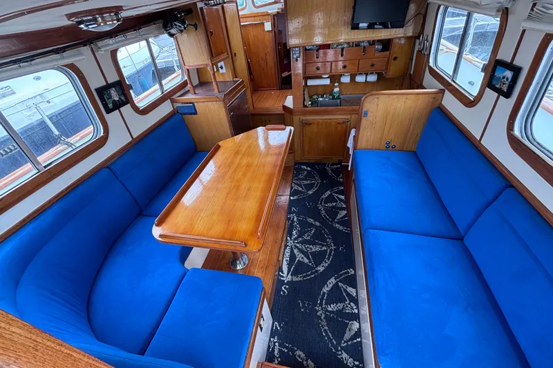 Slide: The Image of Interior of 1985 Transpacific Marine Pacific Eagle 32 with blue seating and wooden finishes. - 18