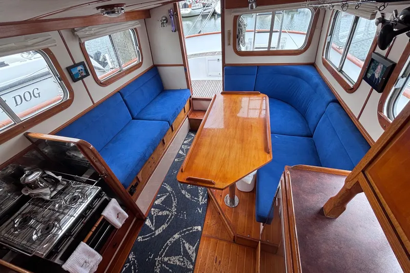 Slide: The Image of Interior of 1985 Transpacific Marine Pacific Eagle 32 with blue seating and wooden table. - 20