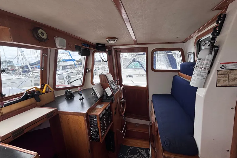 Slide: The Image of Interior of 1985 Transpacific Marine Pacific Eagle 32 boat, featuring helm and seating area. - 24