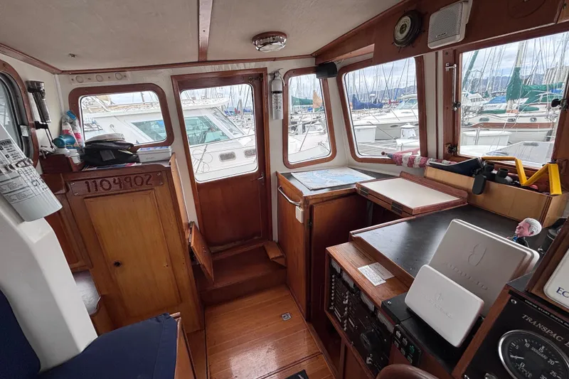 Slide: The Image of Interior of 1985 Transpacific Marine Pacific Eagle 32 boat with navigation equipment and marina view. - 25