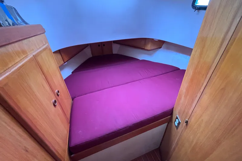Slide: The Image of Cozy cabin interior of 1985 Transpacific Marine Pacific Eagle 32 with purple bedding. - 26