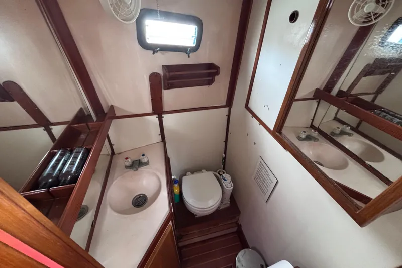 Slide: The Image of Compact bathroom in 1985 Transpacific Marine Pacific Eagle 32 yacht, featuring sink and toilet. - 28