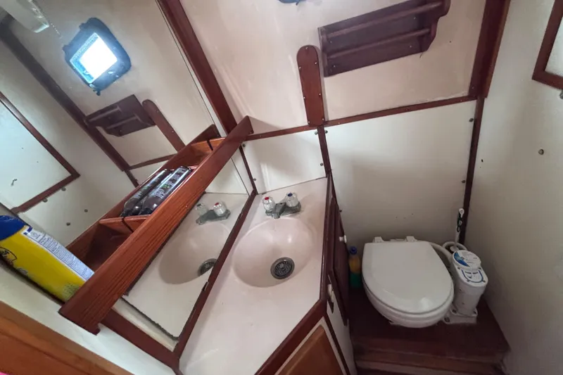 Slide: The Image of Bathroom interior of 1985 Transpacific Marine Pacific Eagle 32 yacht, featuring sink and toilet. - 29