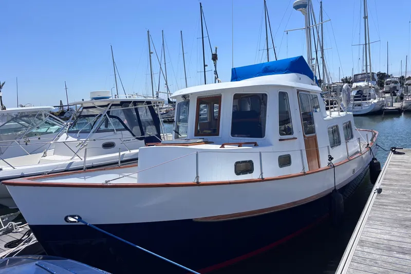 Slide: The Image of 1985 Transpacific Marine Pacific Eagle 32 docked at marina, surrounded by sailboats. - 3