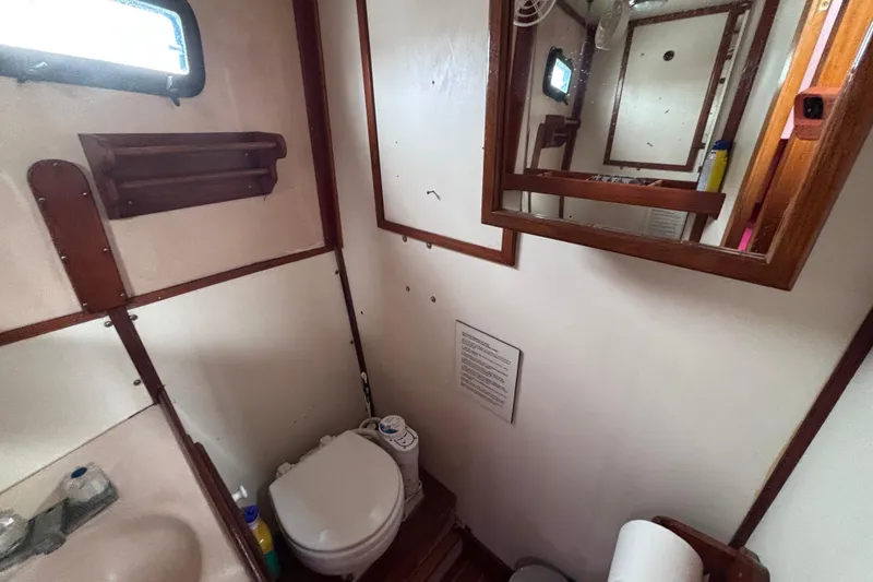 Slide: The Image of Bathroom interior of 1985 Transpacific Marine Pacific Eagle 32 yacht, featuring toilet and mirror. - 30