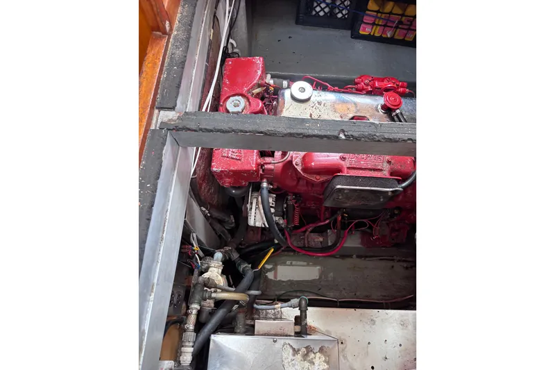 Slide: The Image of Engine compartment of 1985 Transpacific Marine Pacific Eagle 32, featuring red engine components. - 31