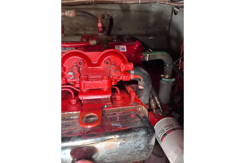 Slide: The Image of Engine compartment of a 1985 Transpacific Marine Pacific Eagle 32, featuring red components. - 34