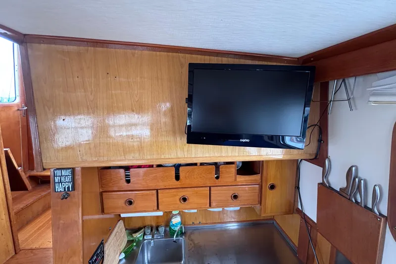 Slide: The Image of Interior of 1985 Transpacific Marine Pacific Eagle 32 with TV and wooden cabinetry. - 39