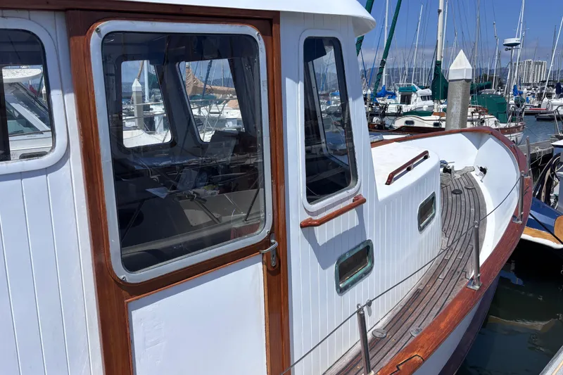 Slide: The Image of 1985 Transpacific Marine Pacific Eagle 32 yacht docked at marina, showcasing wooden deck and cabin. - 4