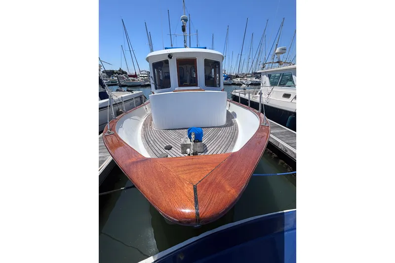 Slide: The Image of 1985 Transpacific Marine Pacific Eagle 32 boat docked in a marina, showcasing wooden deck. - 5