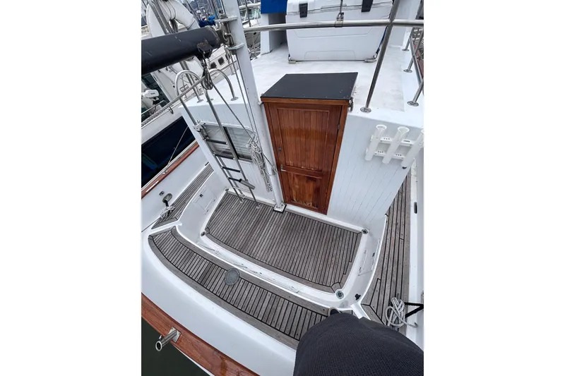 Slide: The Image of 1985 Transpacific Marine Pacific Eagle 32 boat deck with wooden flooring and ladder. - 7