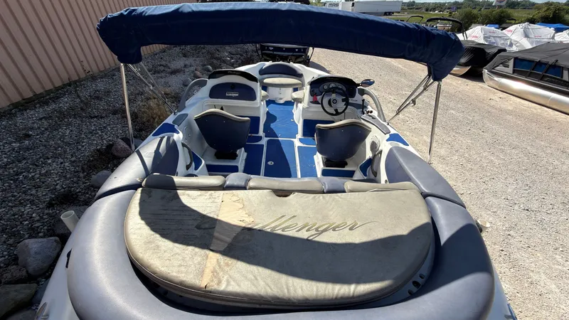 Slide: The Image of A 2002 Sea-Doo Challenger 2000 with blue and gray seats, parked on a trailer. - 7